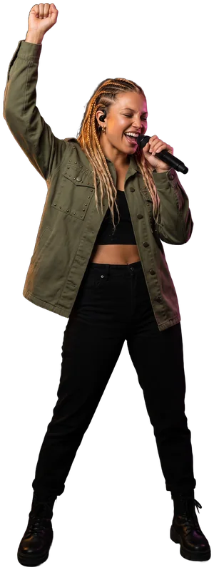 Ro-AN, full body, singing into a handheld microphone, one fist raised, braids, olive jacket.